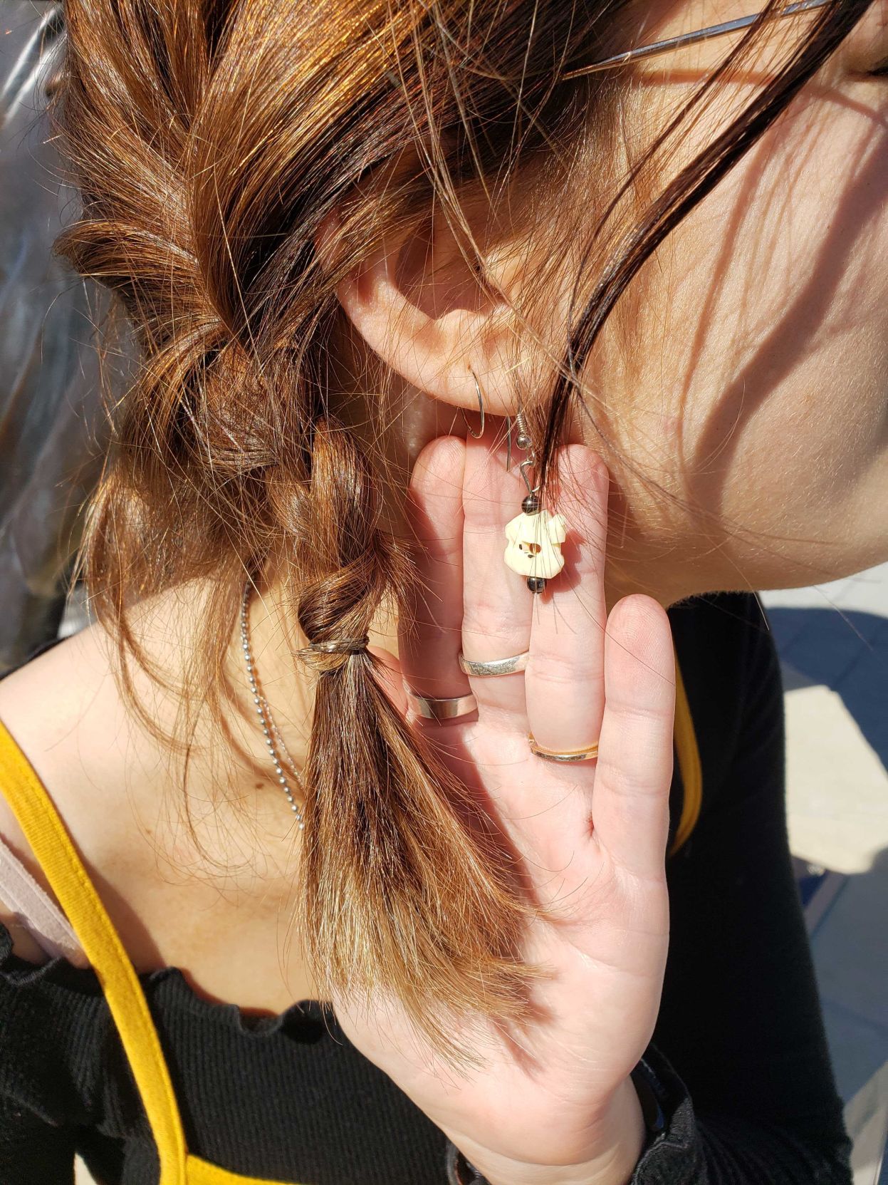 A woman displays her earring